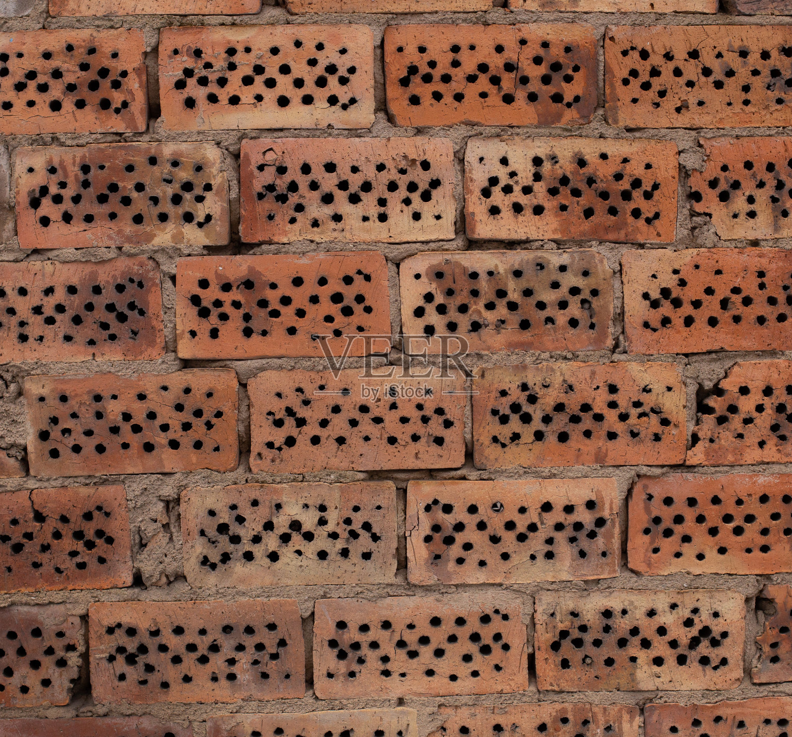 老旧的黄橙红色砖墙背景纹理。照片摄影图片