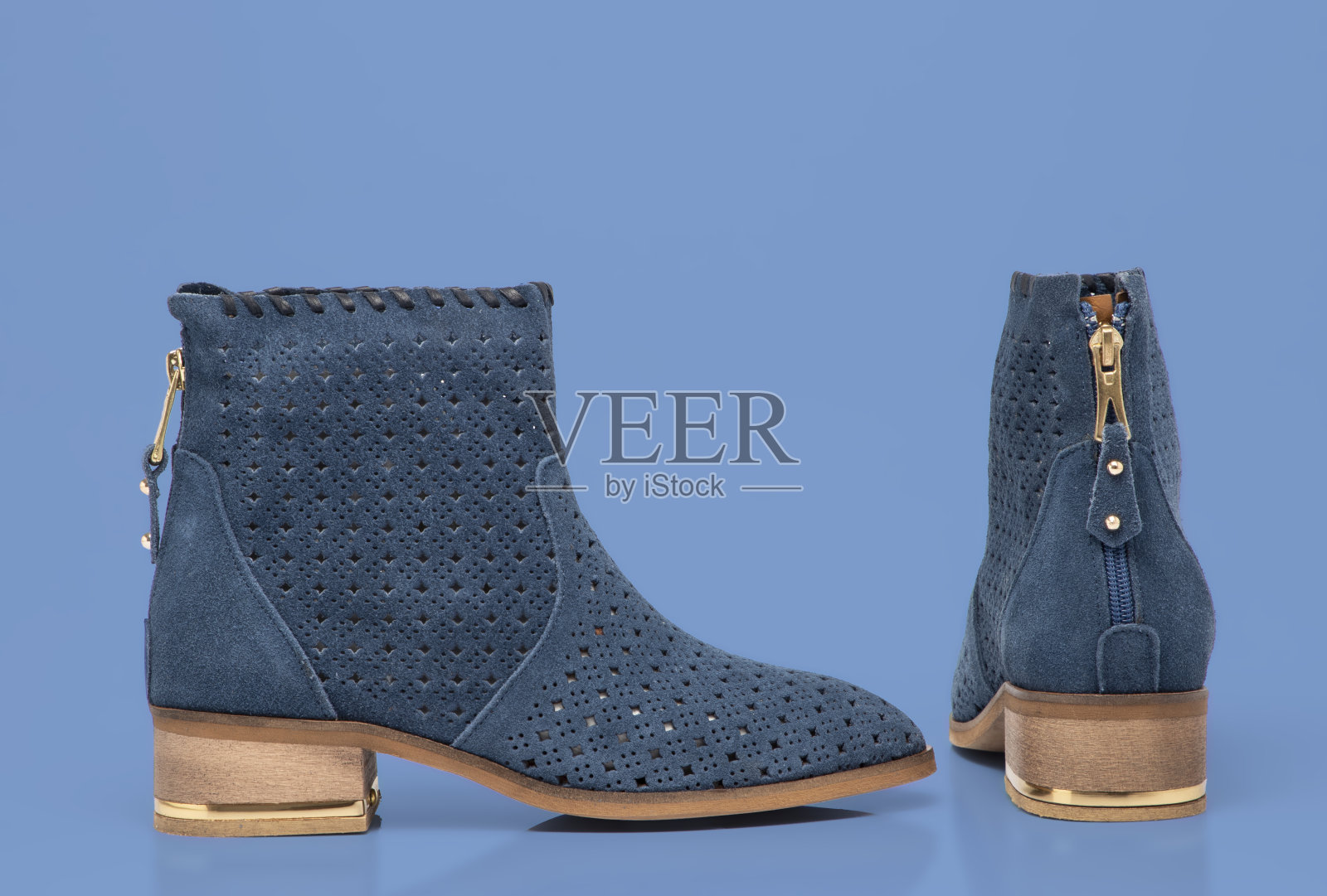 蓝色背景绒面革妇女靴子照片摄影图片