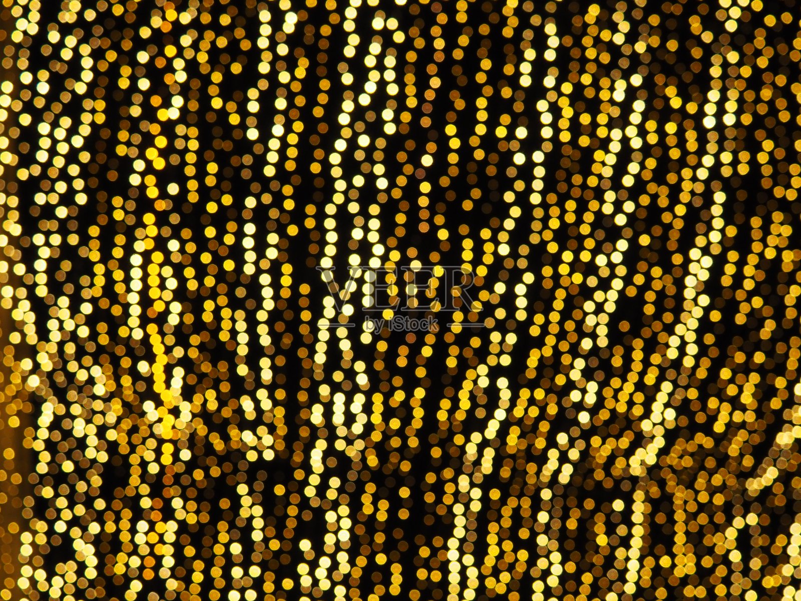 散景集锦。金黄色和黄色在黑暗中闪烁。节日的背景。散焦模糊。城市街道的装饰。许多黄色的球。许多黄色、白色和橙色的圆圈照片摄影图片