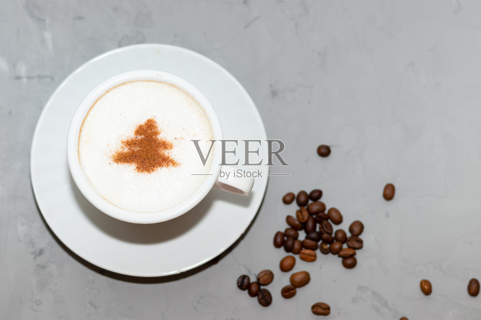 肉桂图案的卡布奇诺咖啡杯，圣诞饮品，在混凝土背景上照片摄影图片