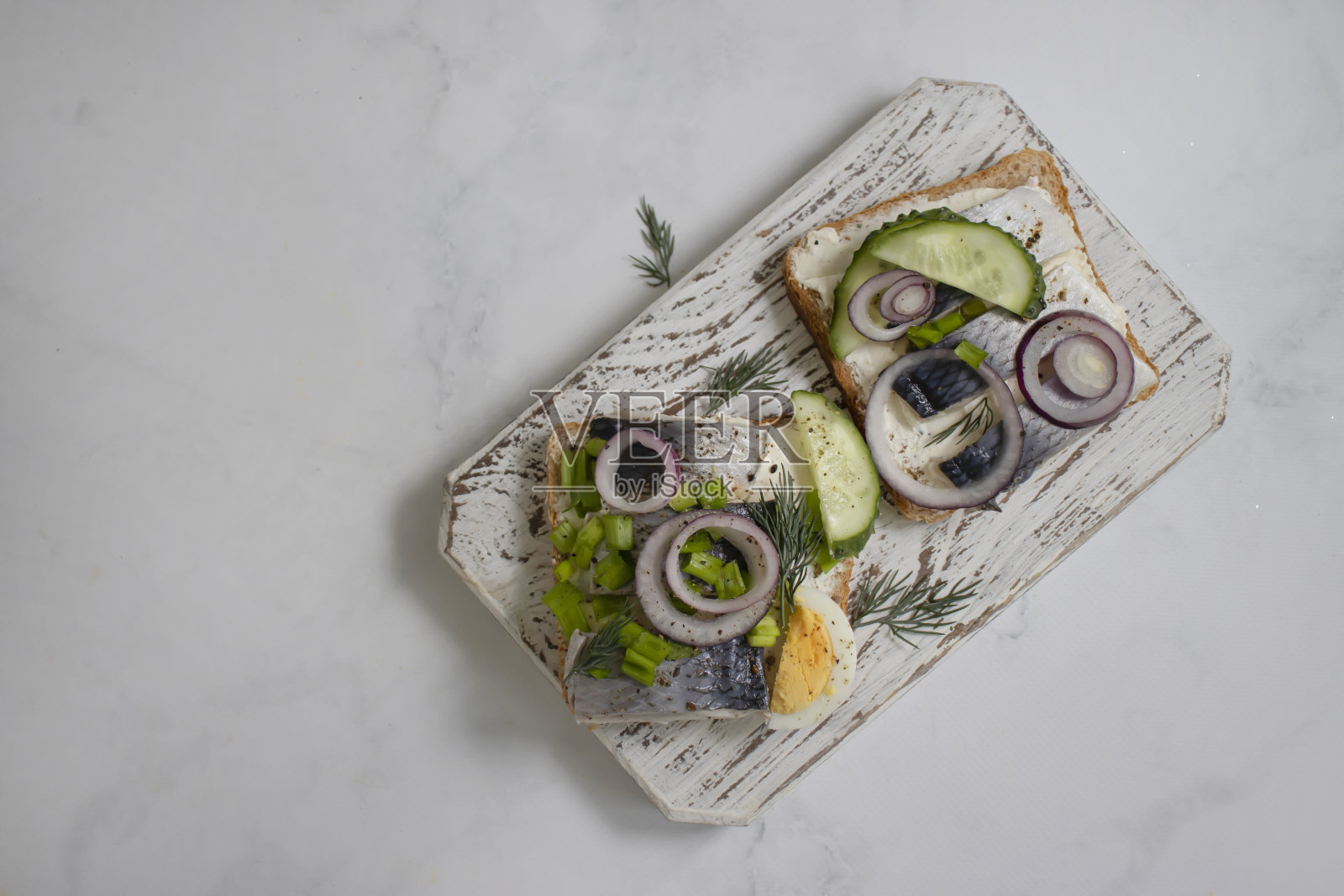 木制背景的青鱼三明治和蓝洋葱照片摄影图片