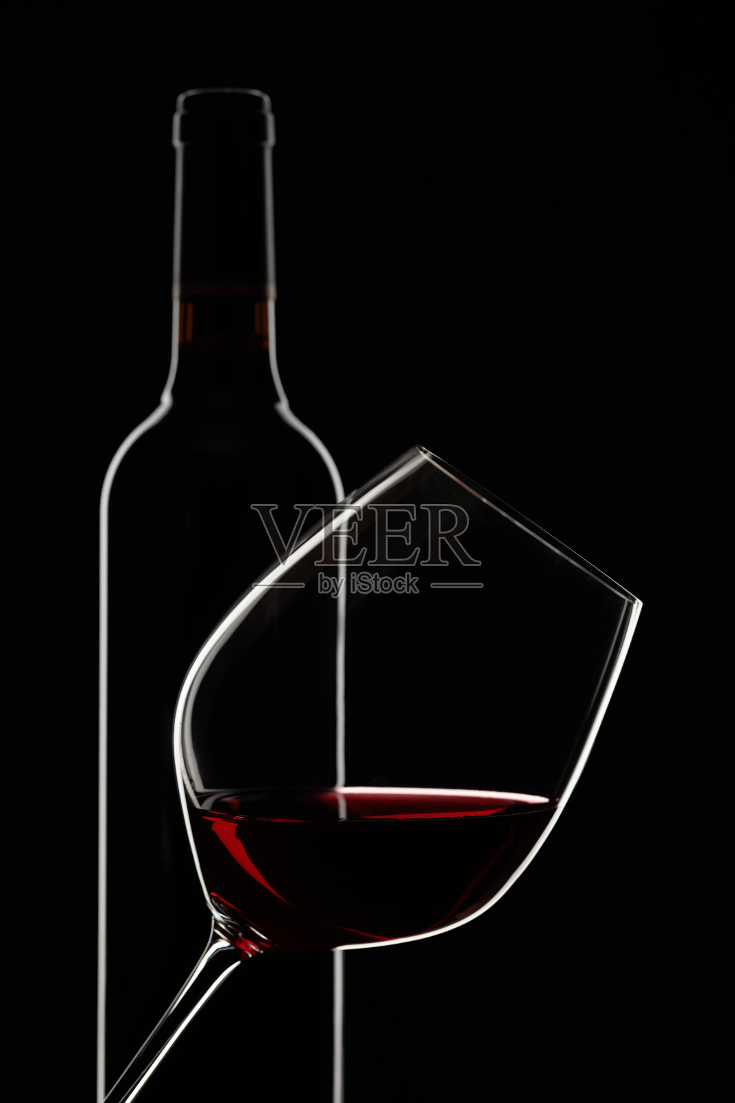 黑色背景的红酒和玻璃杯。照片摄影图片