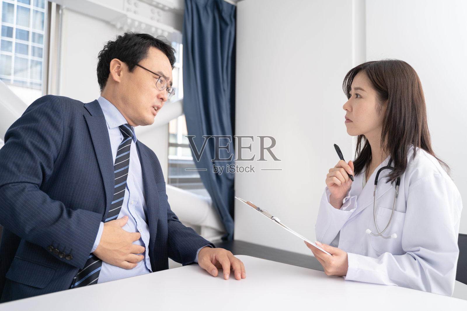 调查问卷中女性医生和男性患者的医学形象照片摄影图片