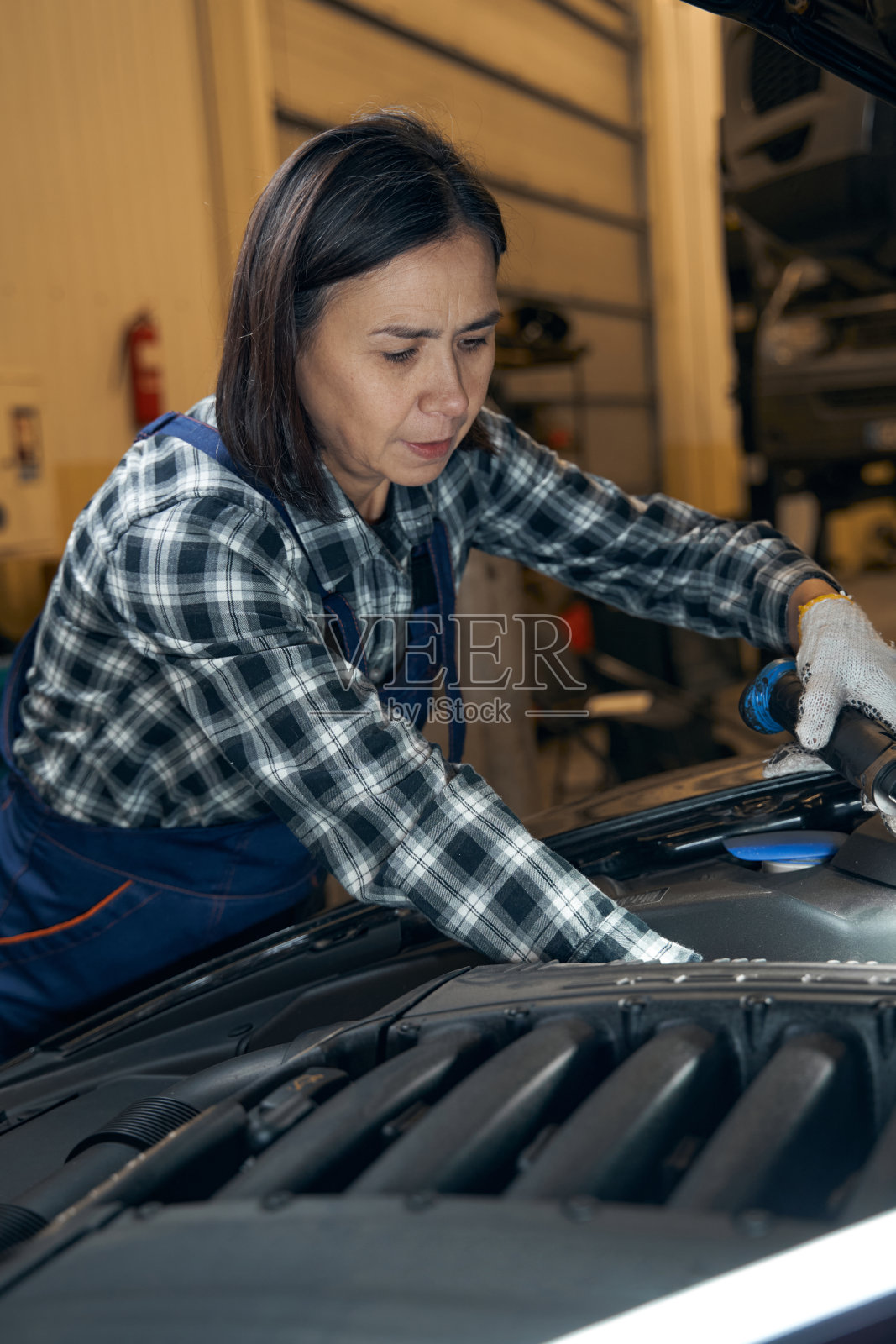 对车辆进行计划好的检查的汽车修理工照片摄影图片