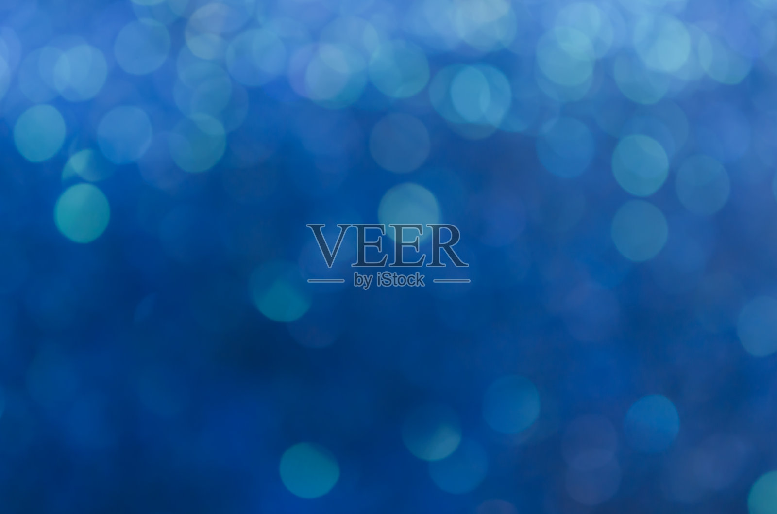 抽象蓝色散景闪闪发光的背景。照片摄影图片