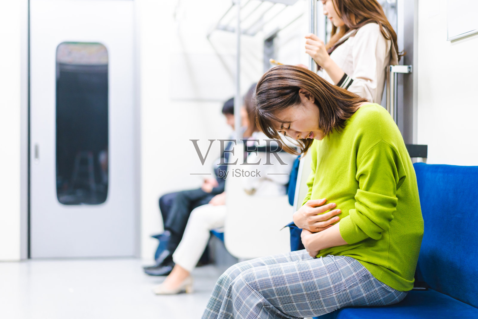 一位孕妇在火车上感到恶心照片摄影图片