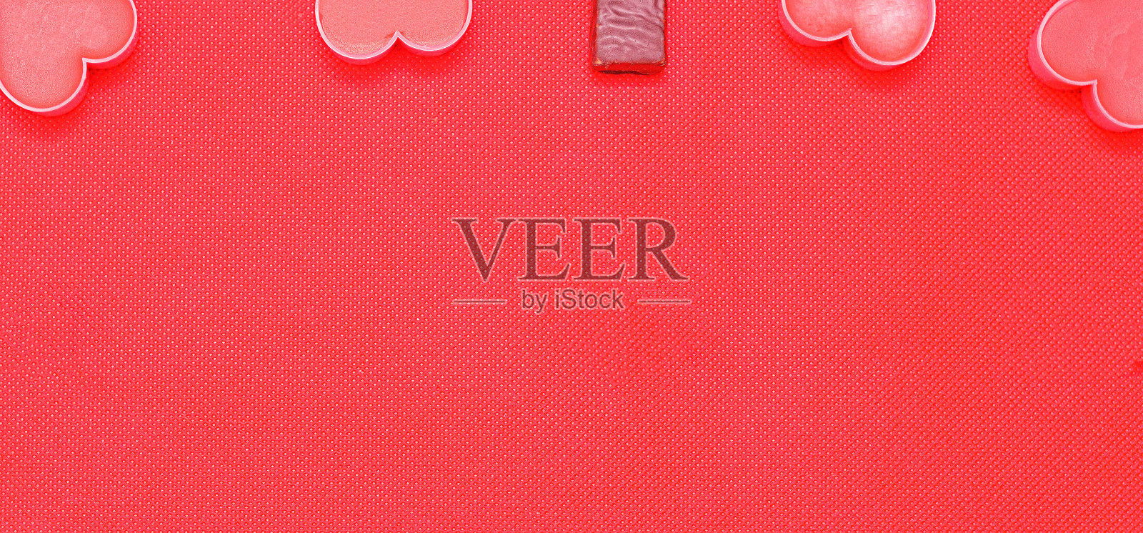 情人节快乐。粉红色的浪漫心和巧克力糖果在粉红色的背景。浪漫情人节背景照片摄影图片