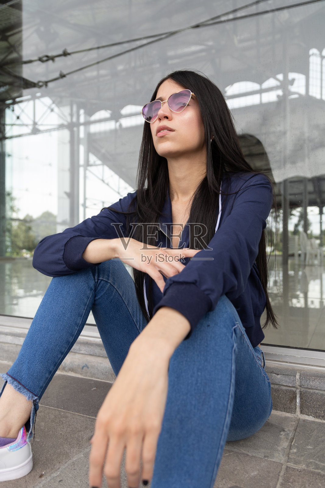 富有魅力的生活方式的年轻拉丁女性模特与时尚的黑色长发摆姿势在城市放松，美丽照片摄影图片