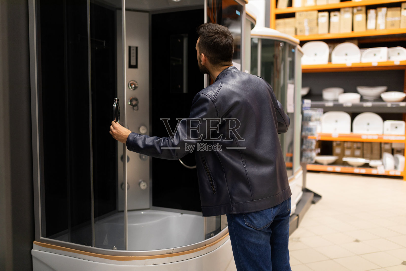 一个五金店的买家仔细检查淋浴间照片摄影图片