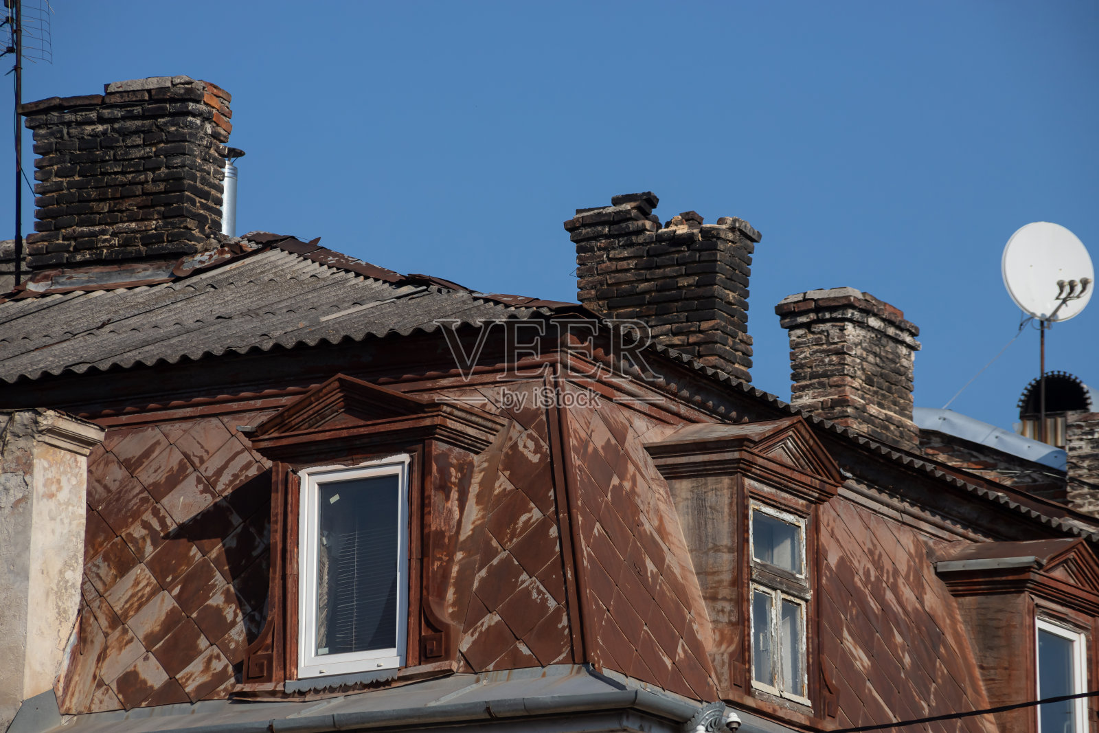 房子的屋顶上盖着一个印有图案的锡罐照片摄影图片