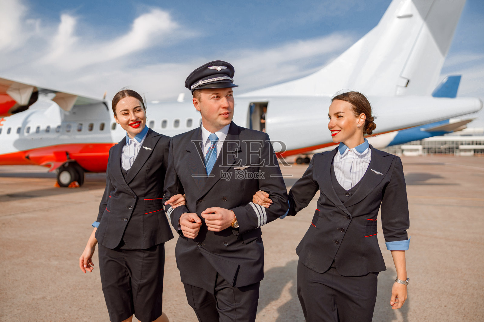 飞行员和空乘人员从机场走下来照片摄影图片