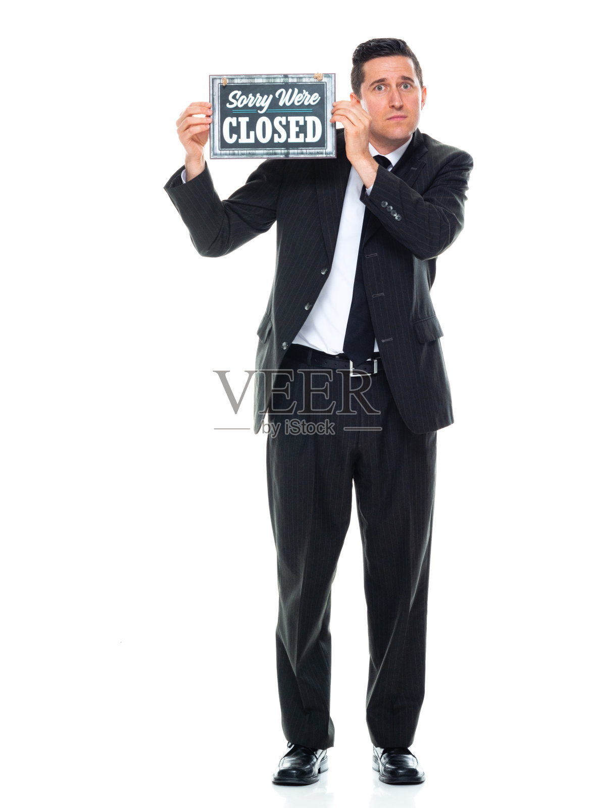 白人男性商人，穿着商务服装，举着横幅站在白色背景前照片摄影图片