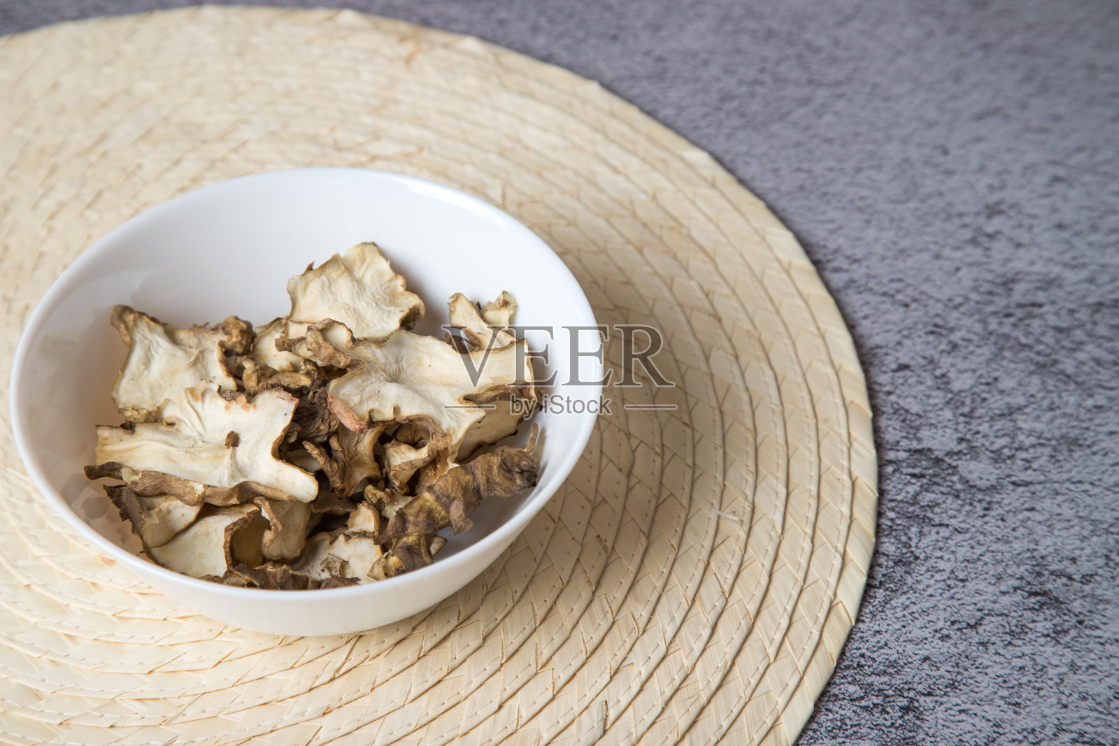 把干的菊芋片放在浅盘里。照片摄影图片