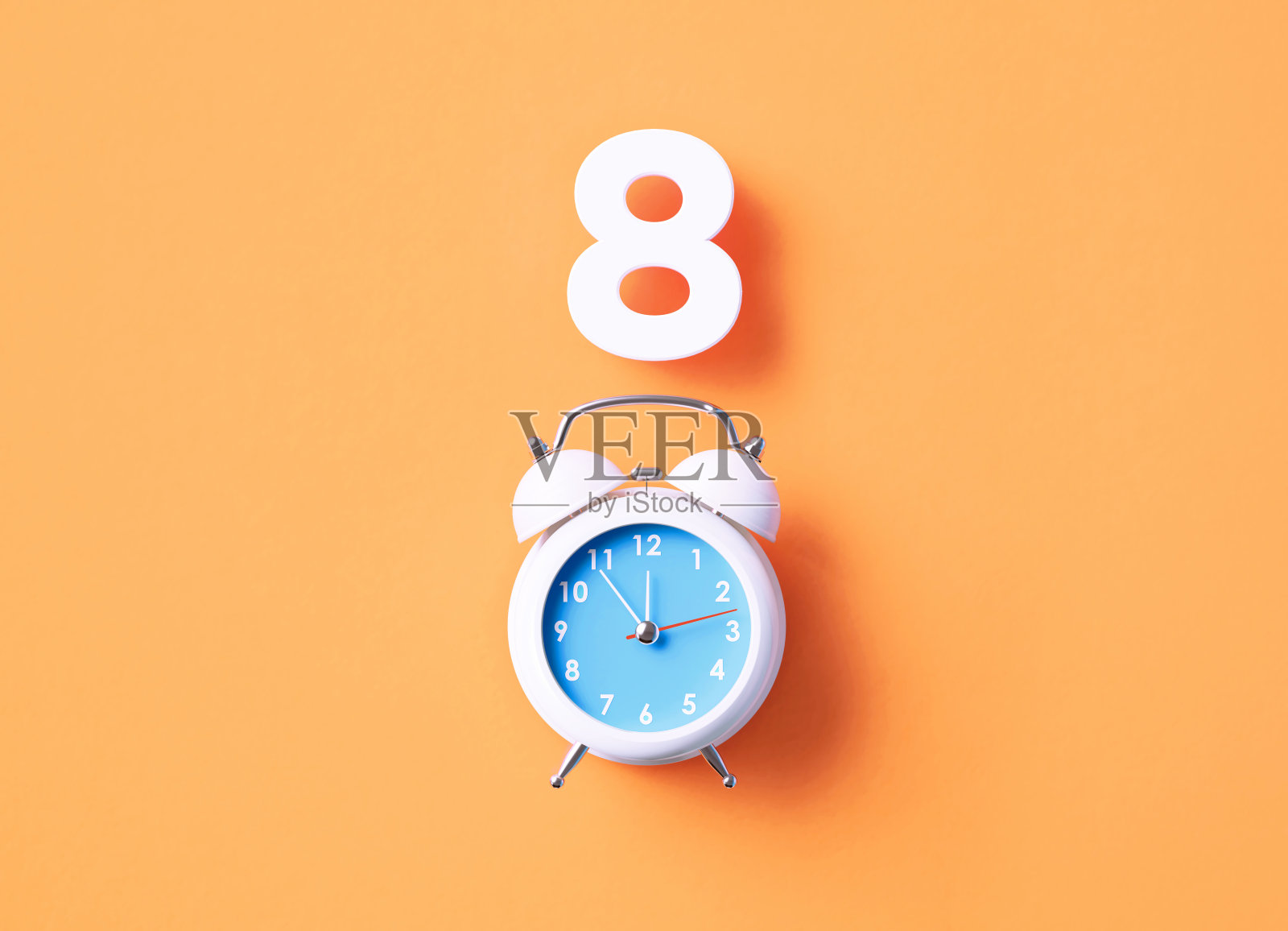 坐在橙色背景的白色闹钟上面照片摄影图片