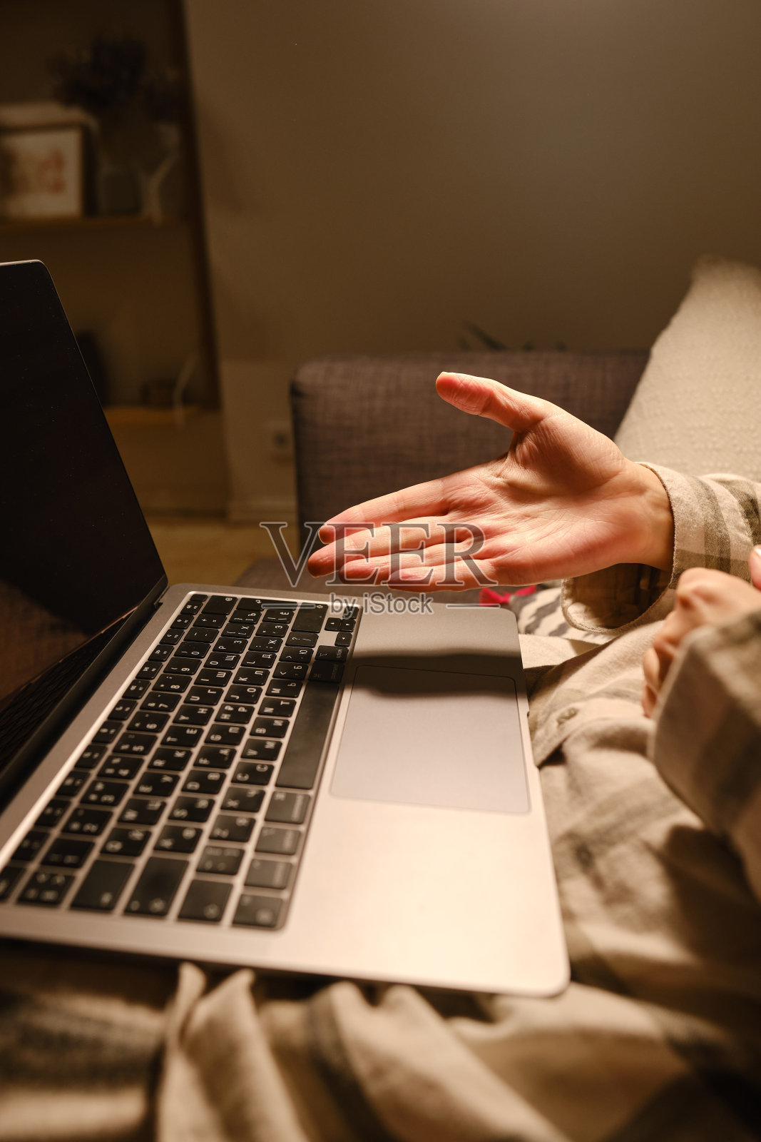 女孩在家里或酒店的床上用笔记本电脑和智能手机工作。遥远的工作。在家办公。卧室里的女人正在笔记本电脑上打字，为学生进行远程教育，上网照片摄影图片