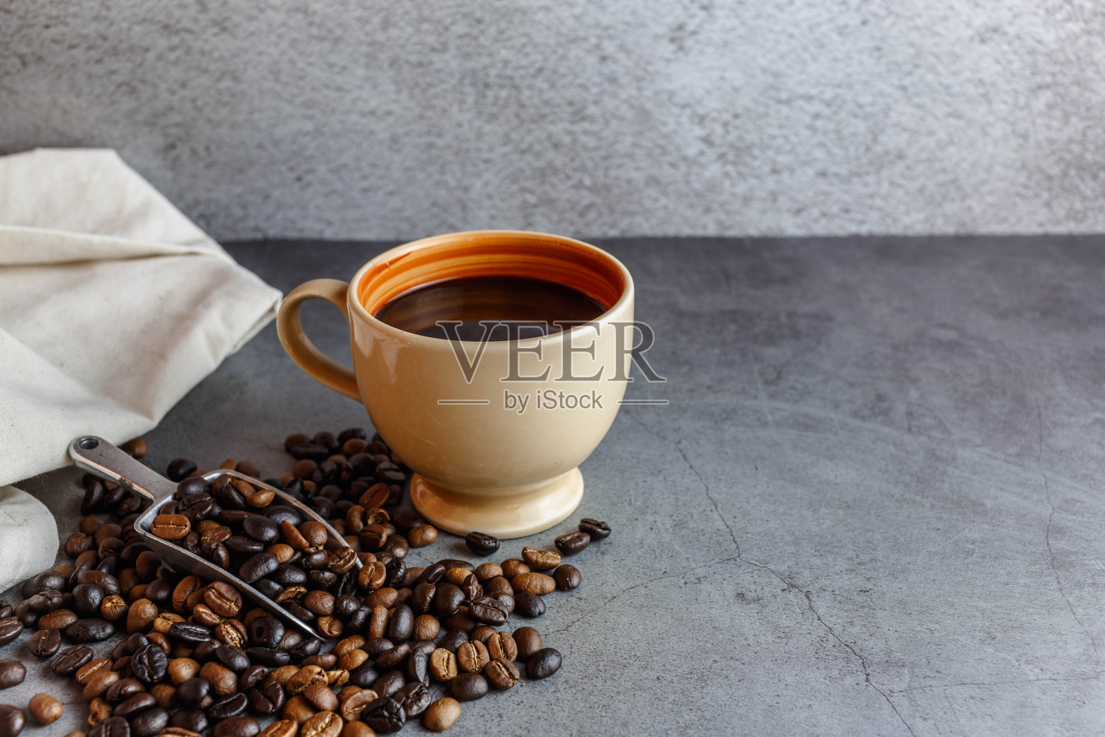 咖啡杯和桌上的咖啡豆照片摄影图片