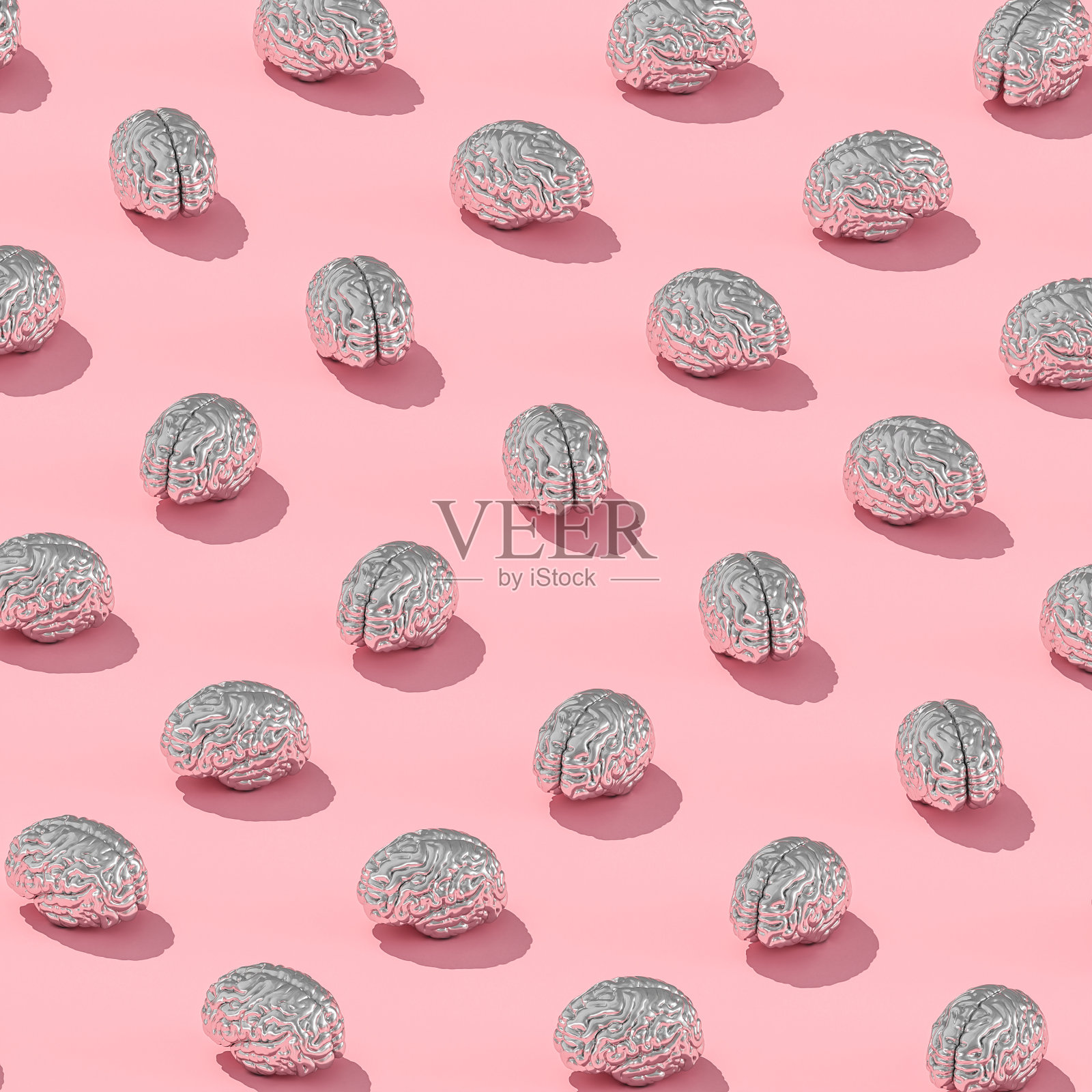 粉红色背景上的金属人脑。照片摄影图片