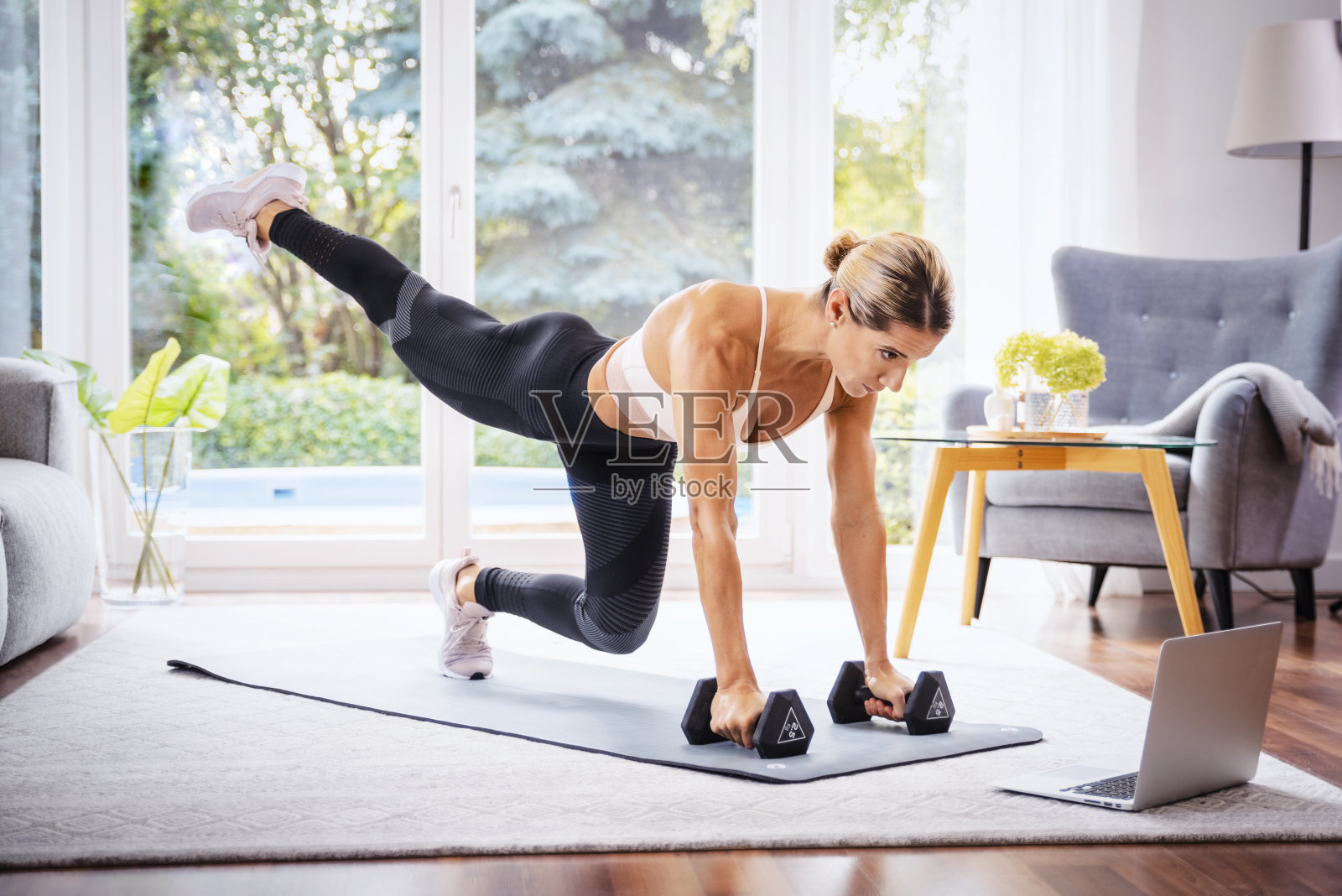 中年妇女在家锻炼时使用笔记本电脑的照片照片摄影图片