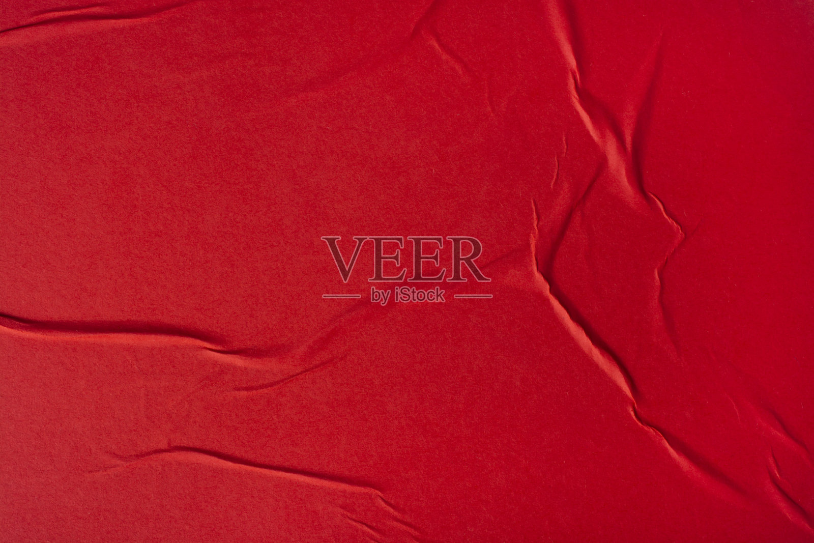 一张有折叠的红纸。照片摄影图片