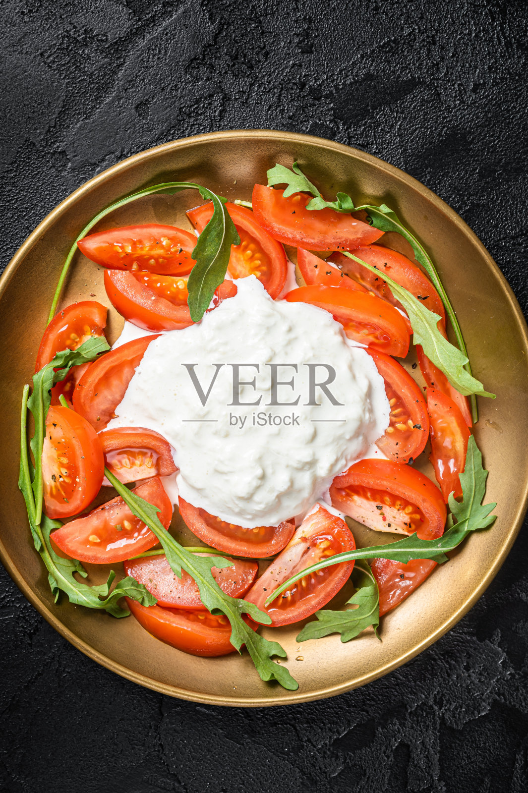 意大利沙拉加奶酪，番茄和芝麻菜。黑色背景。俯视图照片摄影图片