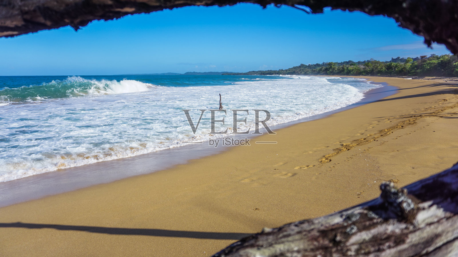 热带夏日的一个岛屿，沙滩和白色的泡沫形成的加勒比海海浪。照片摄影图片