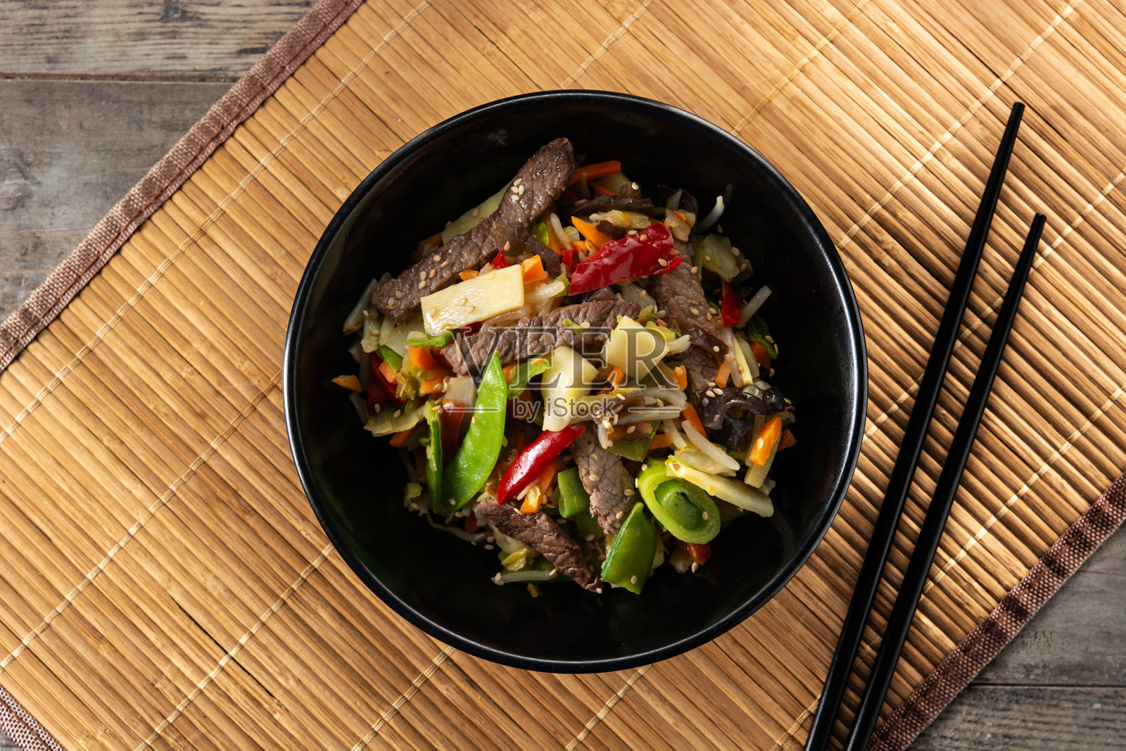 牛肉，蔬菜和芝麻在黑色的碗照片摄影图片