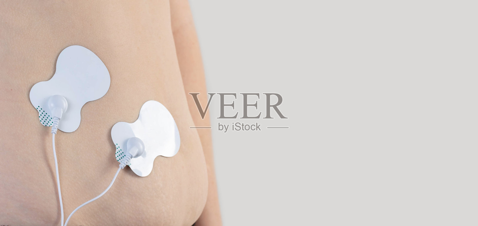 一种现代的电子针灸，燃烧腹部脂肪，增强女孩身体的肌肉。文本的复制空间照片摄影图片