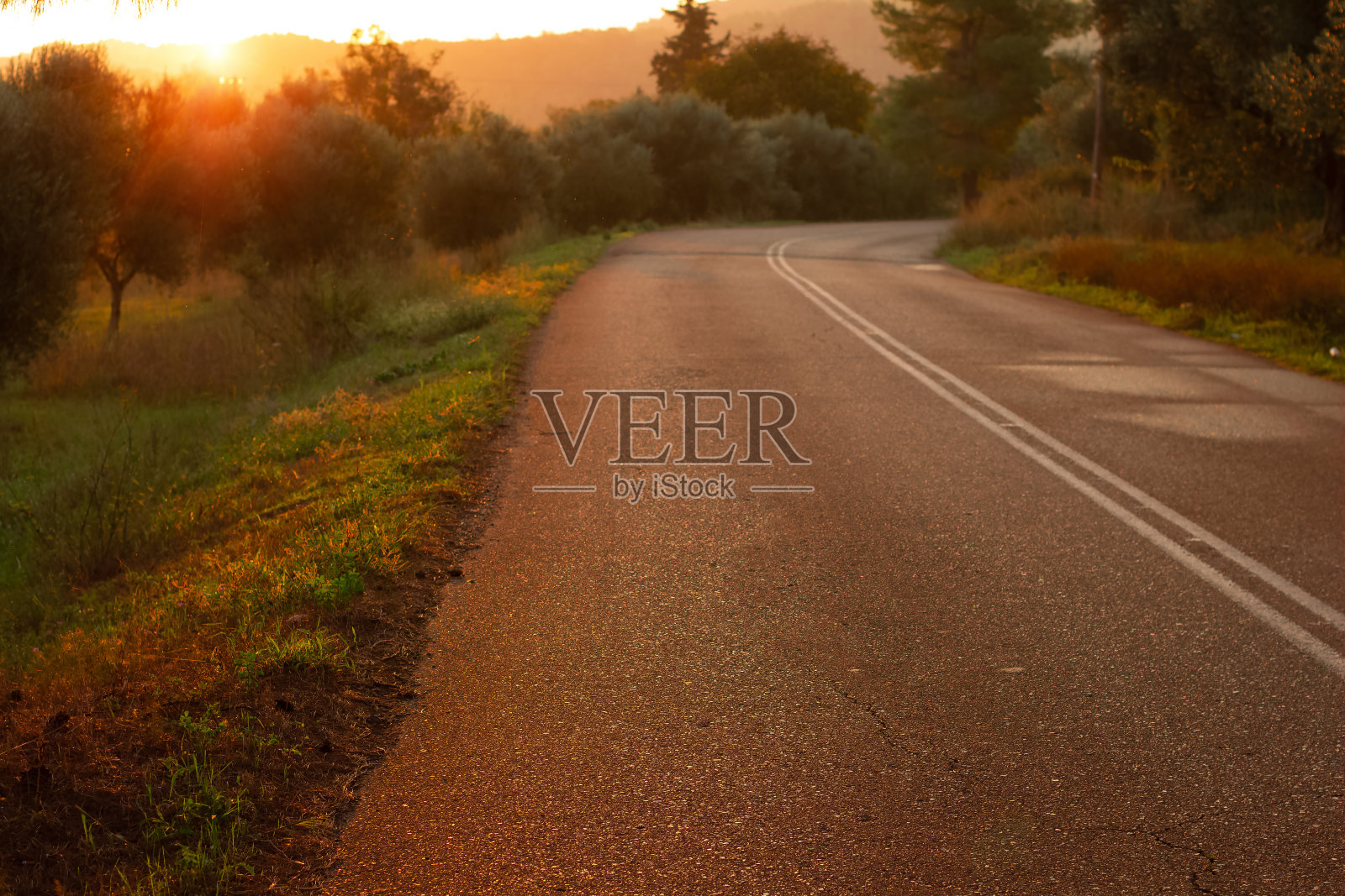 前景沥青纹理集中在道路、郊区、乡村环境、日落、傍晚、桔黄色灯光公园等户外景色照片摄影图片