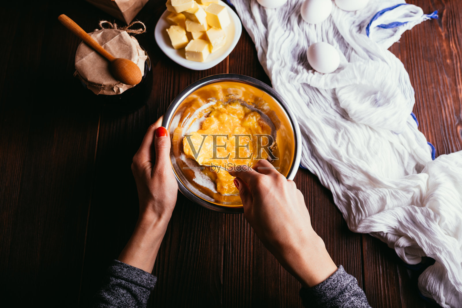 正在做馅饼。用女性的手搅拌糖和蛋黄照片摄影图片