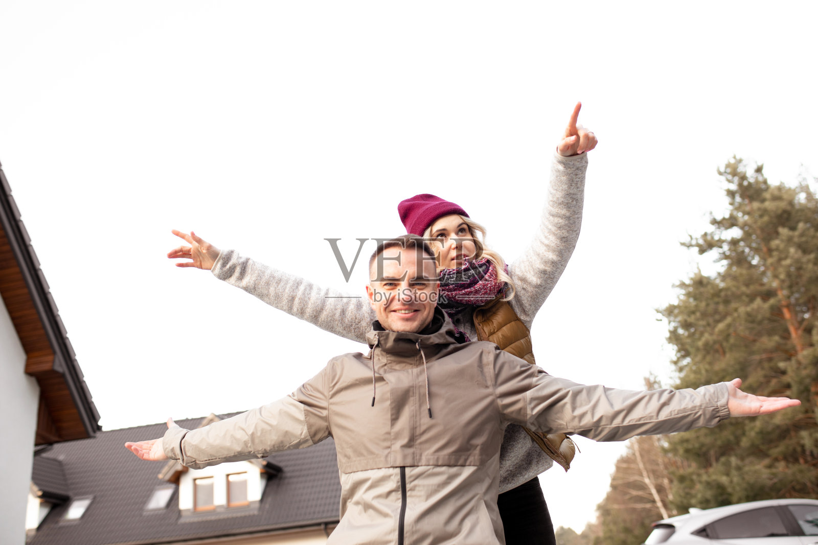 两个人的肖像幸福微笑的夫妇，黑头发的男人和金发的女人在帽子围巾寒冷的天气低角度照片摄影图片