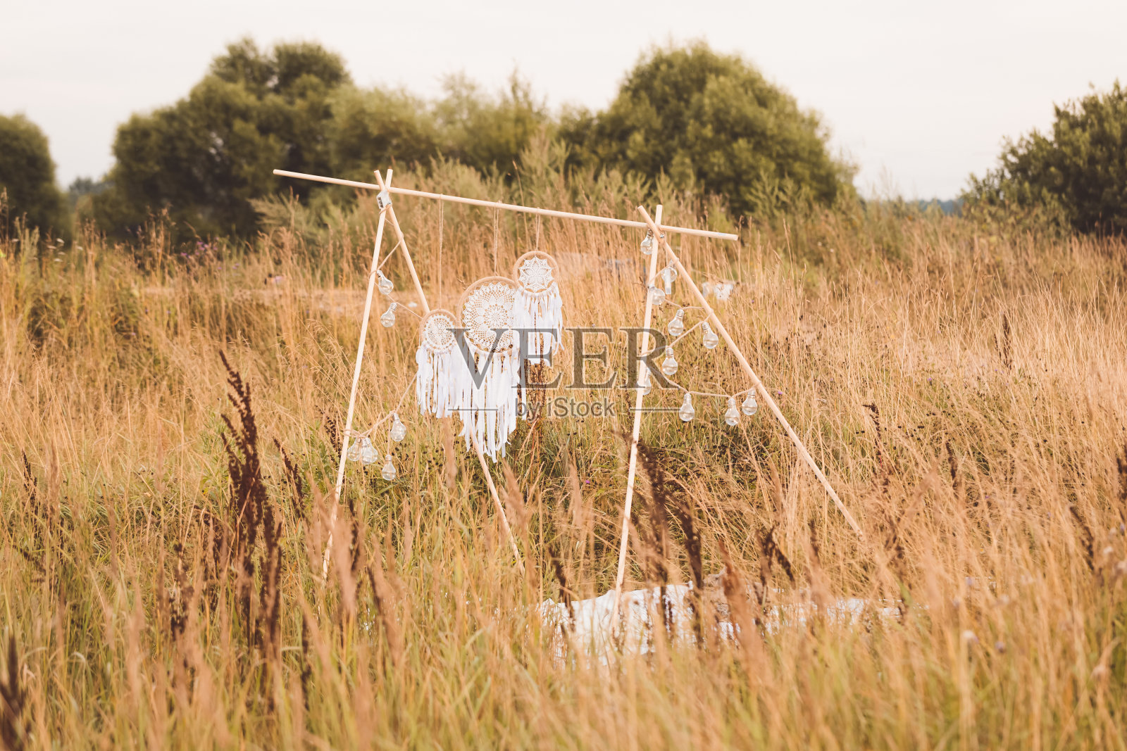 白色棉捕梦网在自然的夏季背景，柔软的选择性焦点，色调照片摄影图片