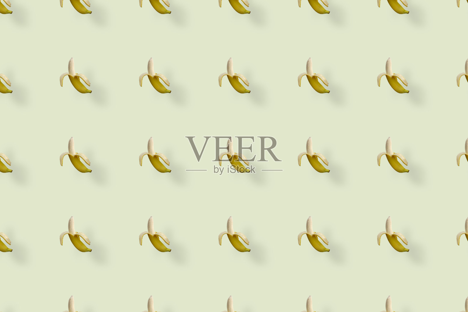 黄色香蕉在浅黄色背景上的彩色果实图案。前视图。平的。波普艺术设计照片摄影图片