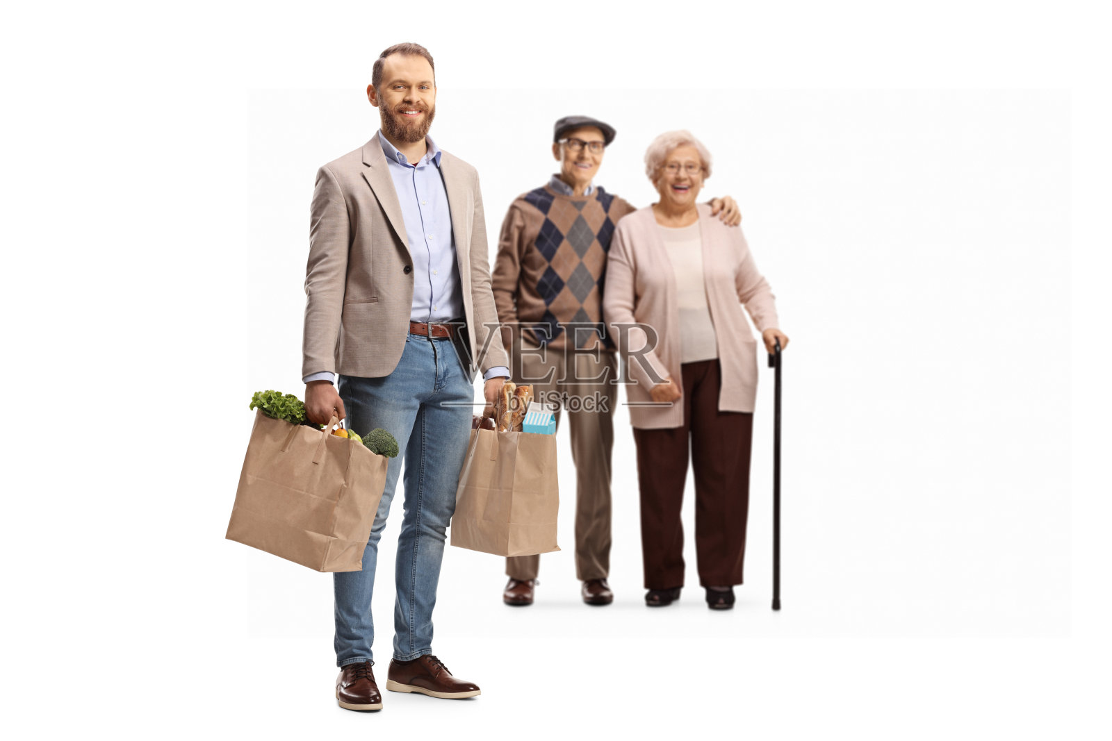 一个年轻人拿着购物袋帮助一个老人和一个女人照片摄影图片