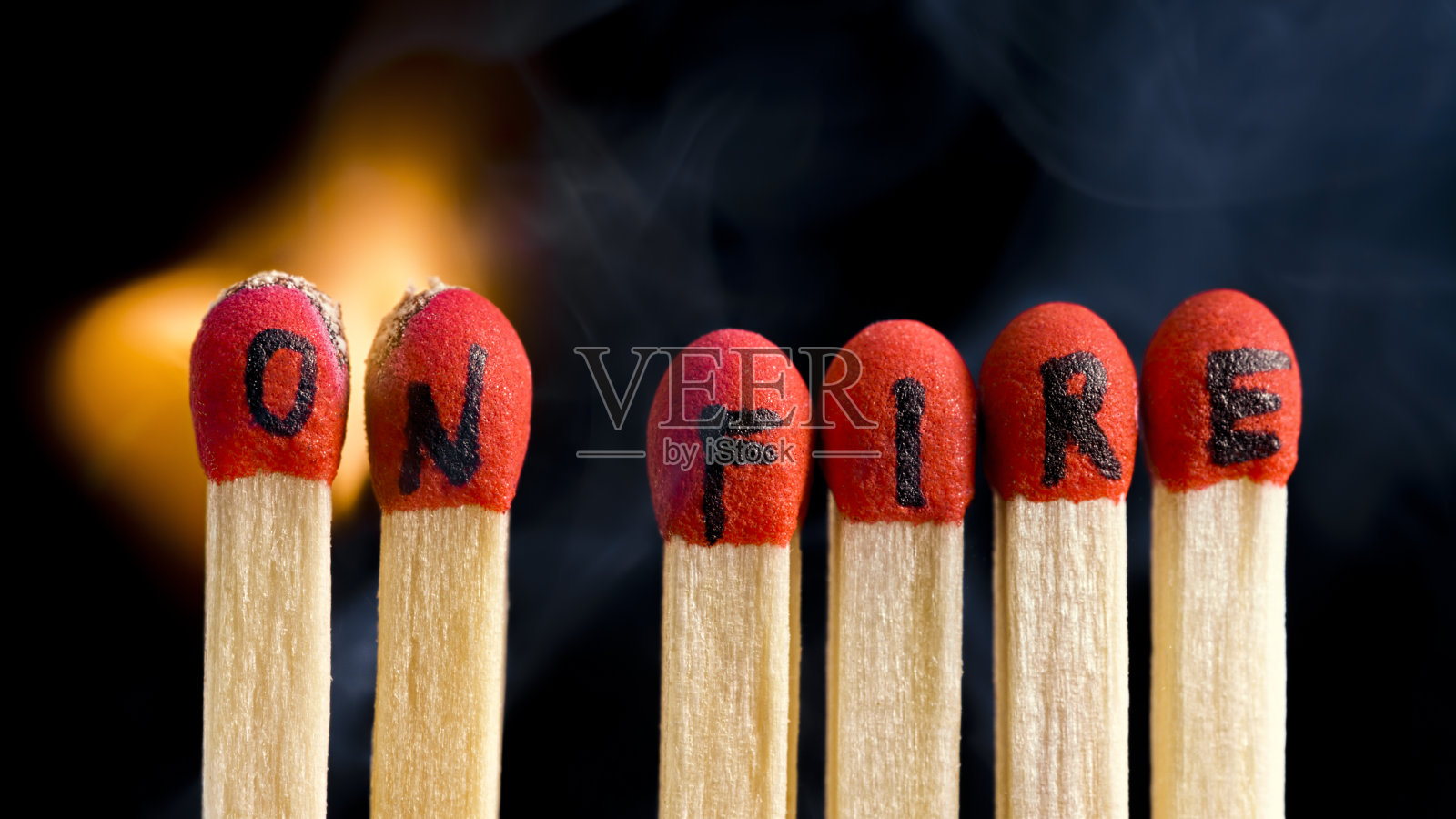 刻有“无火”字样的火柴棒被点燃了照片摄影图片