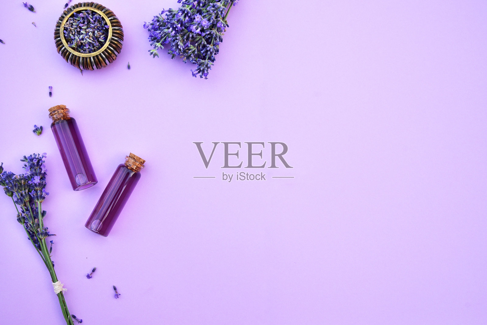 淡景背景上的薰衣草油和薰衣草花。照片摄影图片