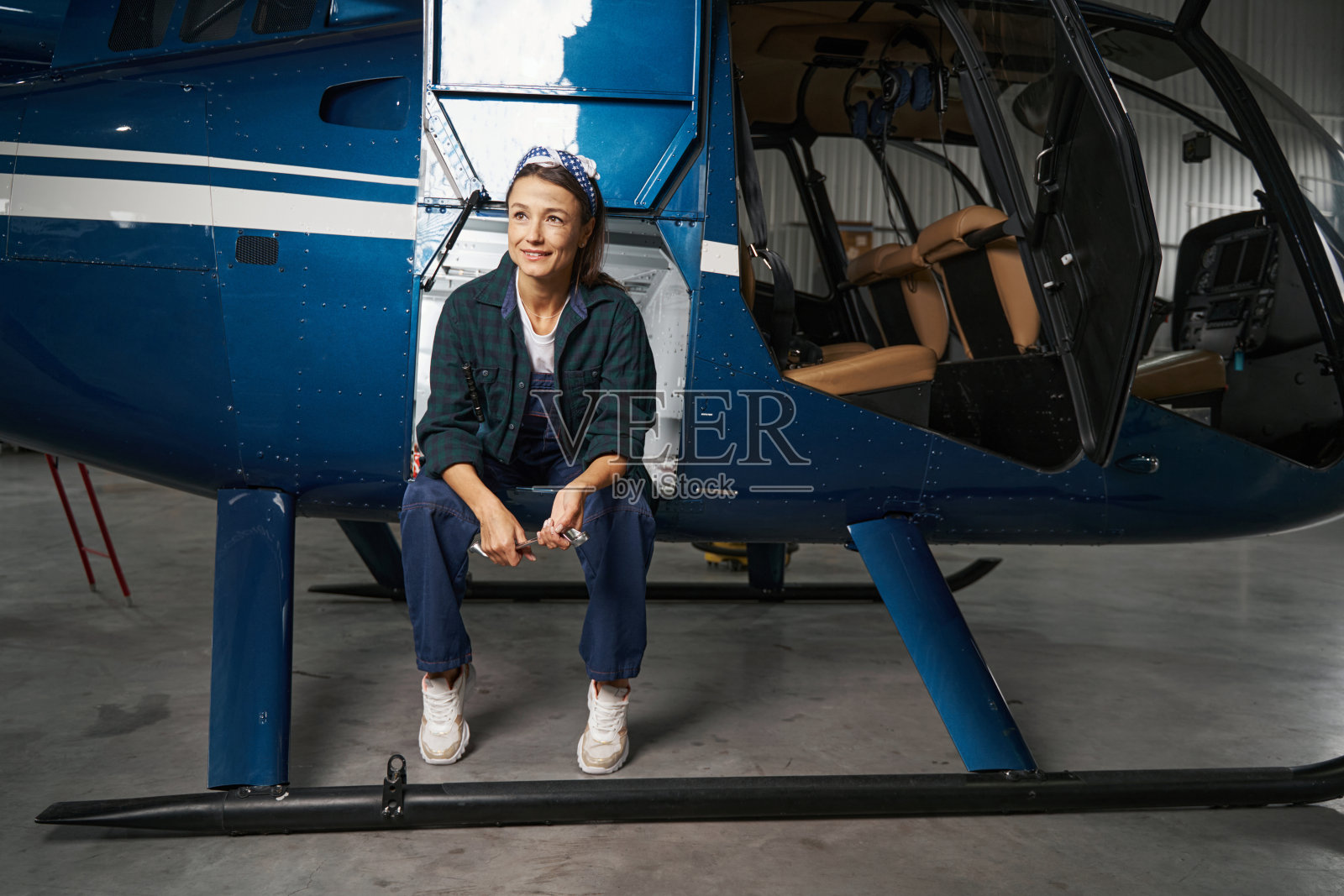 黑发女工程师在机库休息时休息照片摄影图片