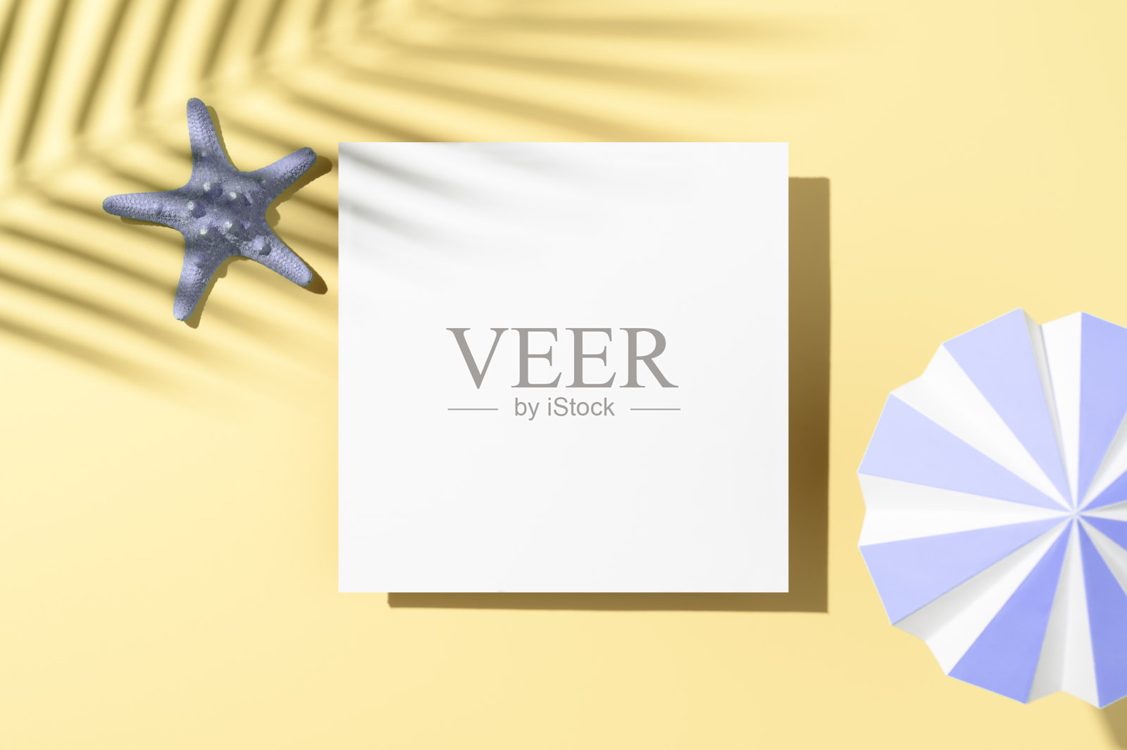 最小的夏季现代模型。白色平坦空白卡片，遮阳伞，和在柔和的米色背景与棕榈叶阴影叠加的海星。展示化妆品的陈列柜。俯视图照片摄影图片