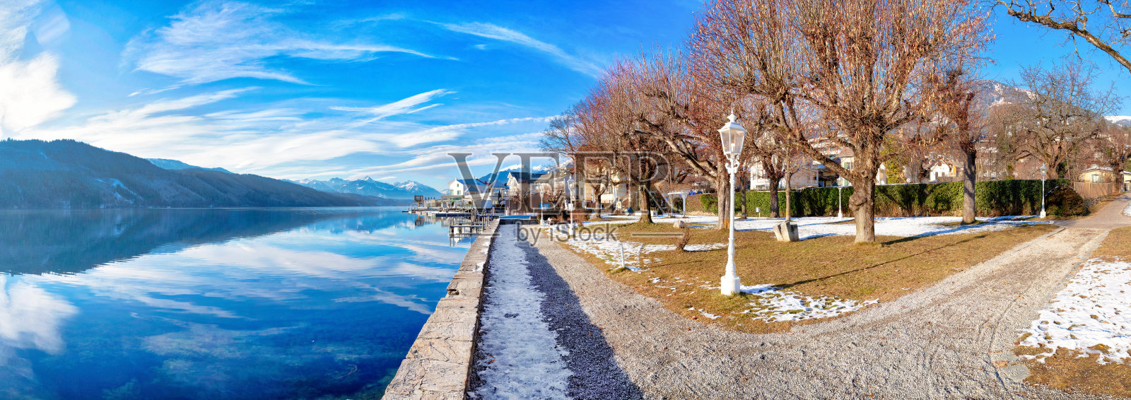 奥地利阿尔卑斯山脉的米尔施塔特湖的全景。这个湖被高山环绕着。照片摄影图片