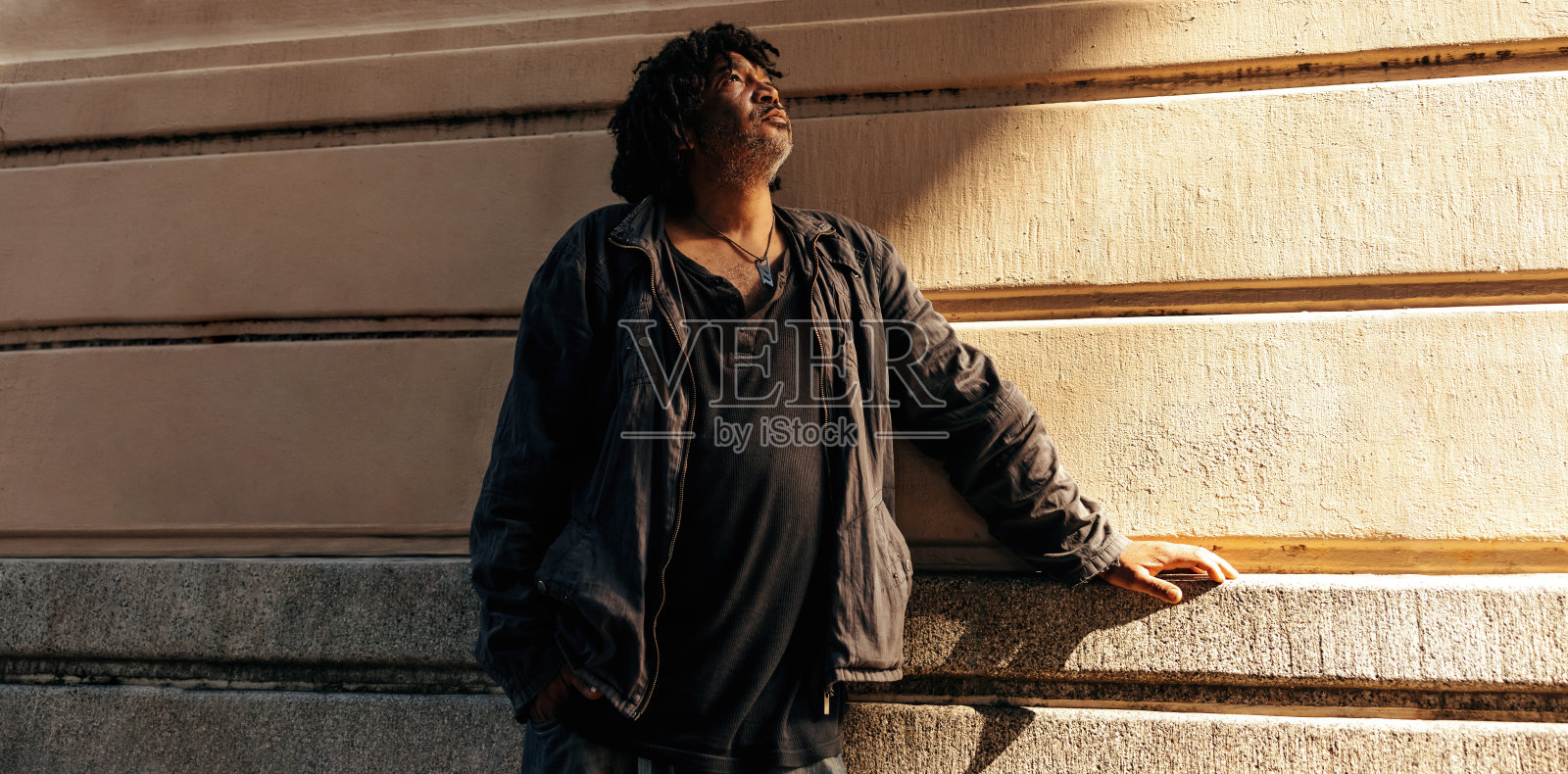 有思想的流浪汉在户外仰望照片摄影图片