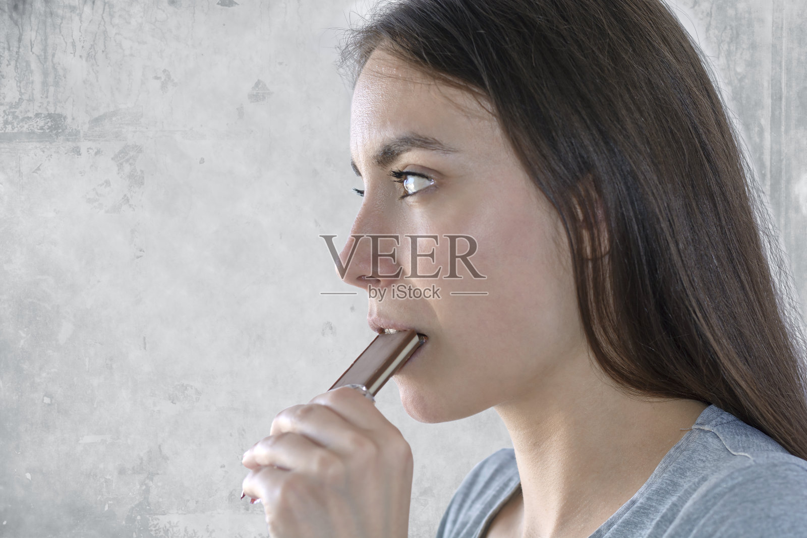 一个女人吃着巧克力棒享受的特写照片摄影图片