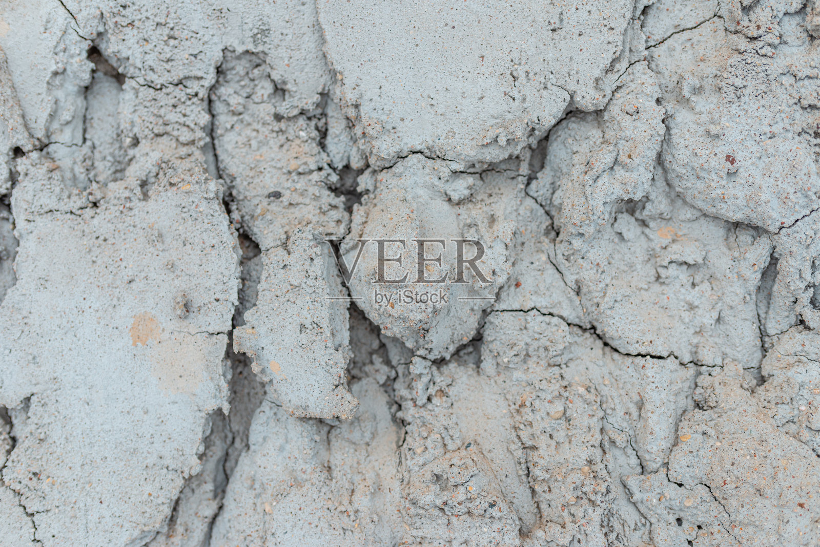 裂缝混凝土墙灰色水泥表面背景。冬天破碎的灰色石墙。特写镜头。照片摄影图片