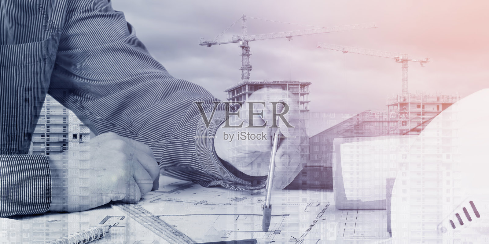 工程师、建筑师在建筑工地的背景下设计新建筑。照片摄影图片