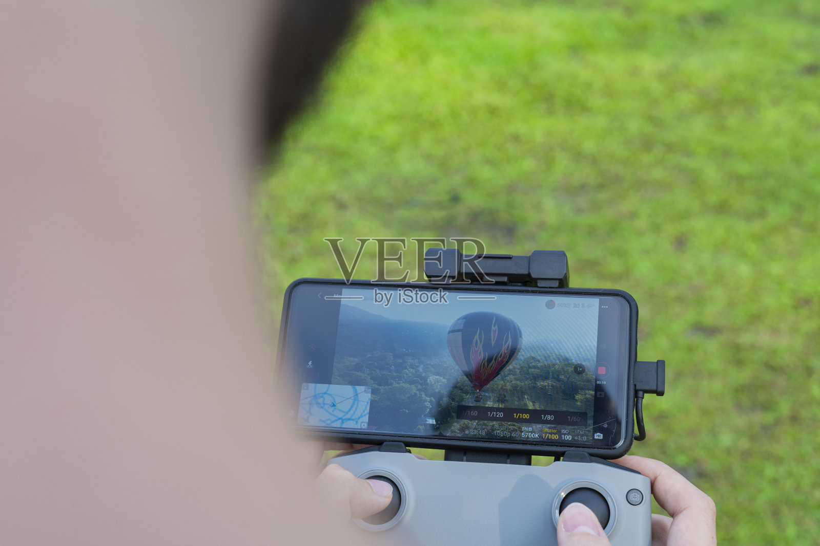 一名男子从上方驾驶无人机，从屏幕上观看它照片摄影图片