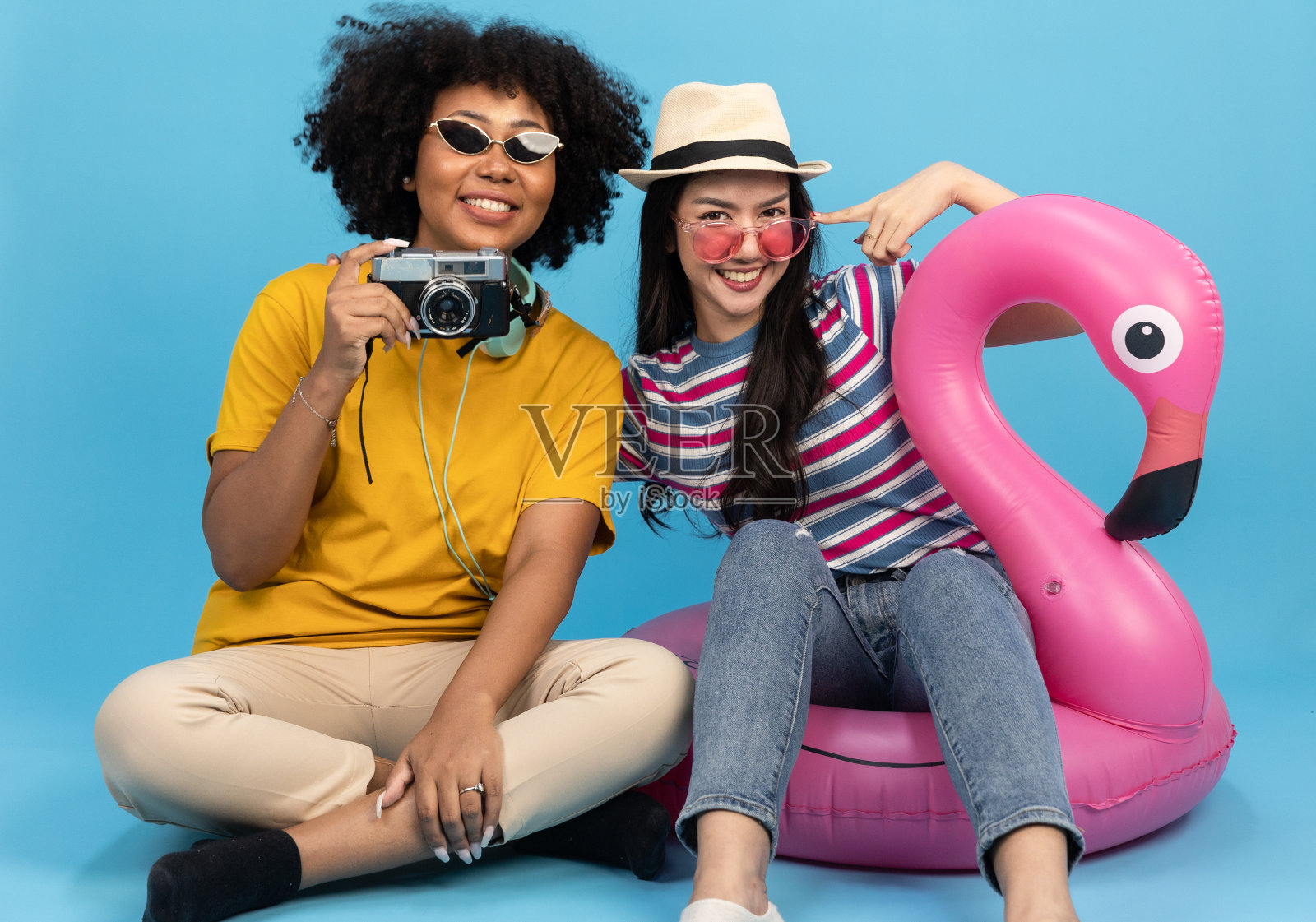 穿着夏日休闲装的女游客。亚洲微笑女人。旅客出国旅行，以黄色为背景。亚洲女人要去度暑假。旅行有趣的旅行。照片摄影图片