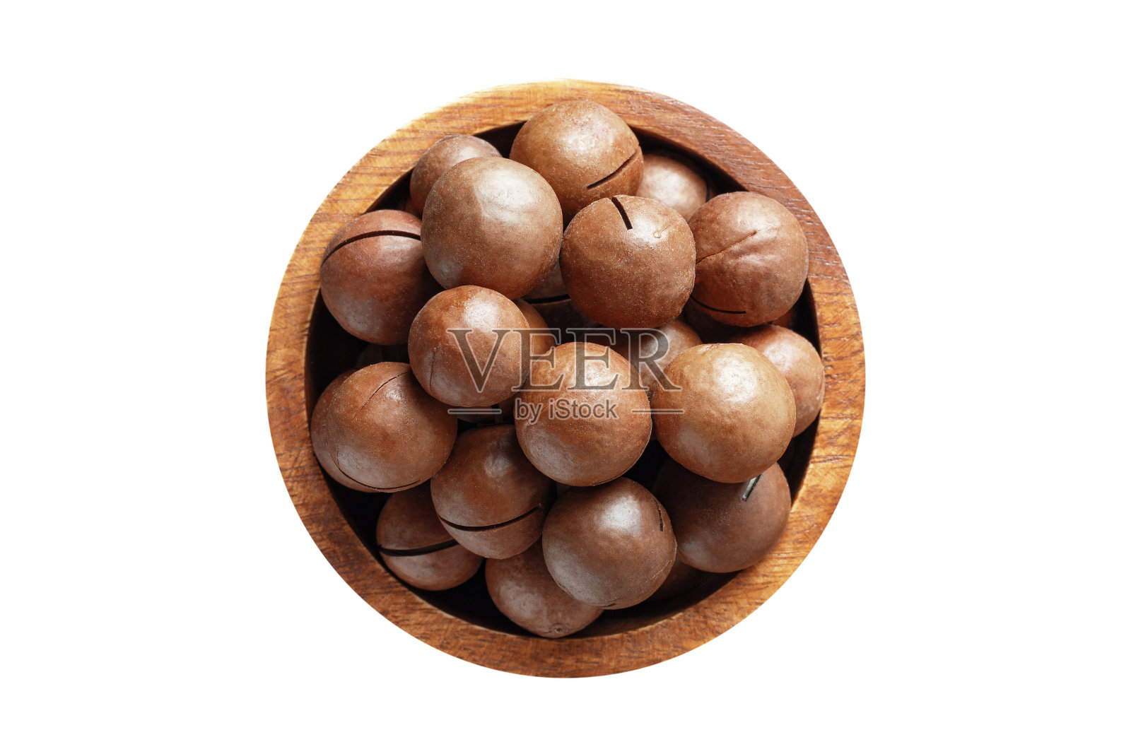 去壳的澳洲坚果在木碗孤立的白色背景。素食，俯视图。照片摄影图片