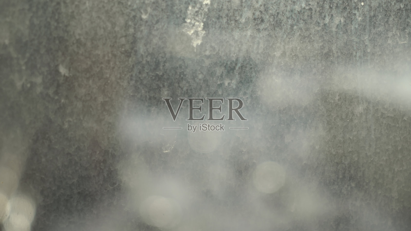 肮脏的窗口。玻璃上沾有灰尘、污垢和雨雪滴照片摄影图片