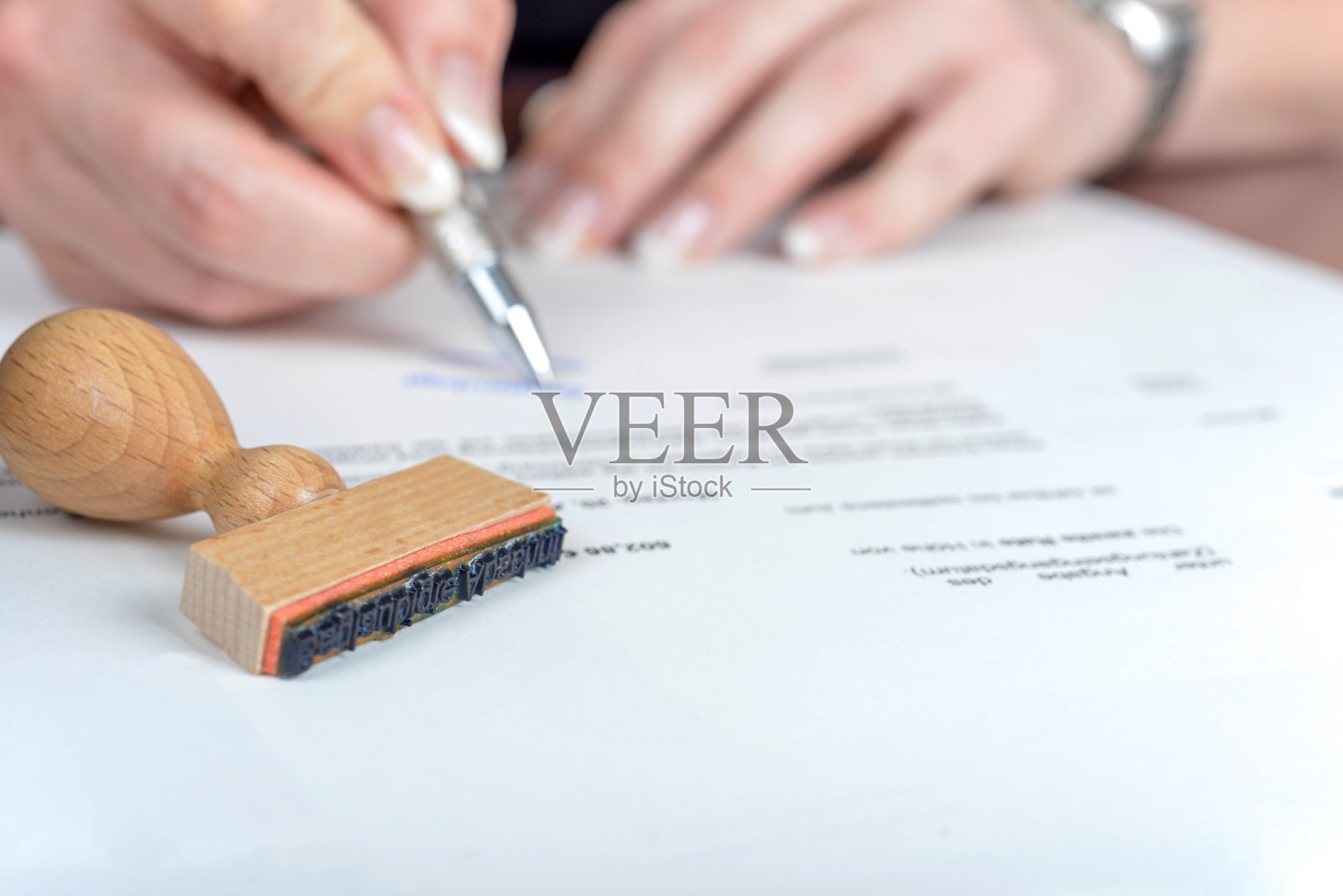 在她的办公室里，一个女商人用一支银色的笔签名和文书工作的手的特写镜头照片摄影图片