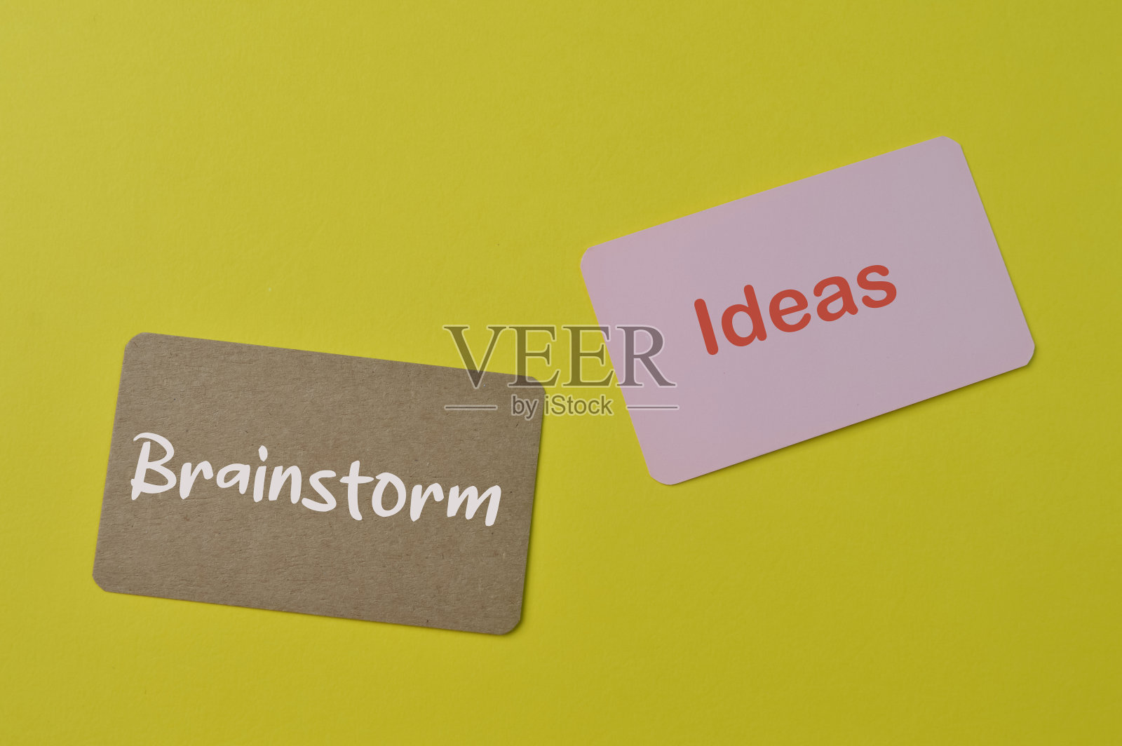 粉红色的卡片和棕色的卡片写的文字想法和头脑风暴照片摄影图片