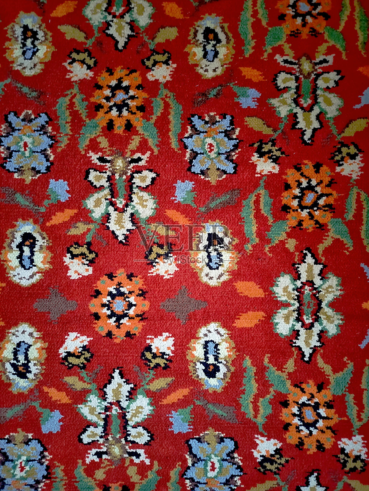 波斯地毯的纹理，抽象的点缀。圆形曼陀罗图案，传统的中东地毯织物纹理。红色，乳绿色，米色，浅绿色，棕色。复古,东方主题照片摄影图片