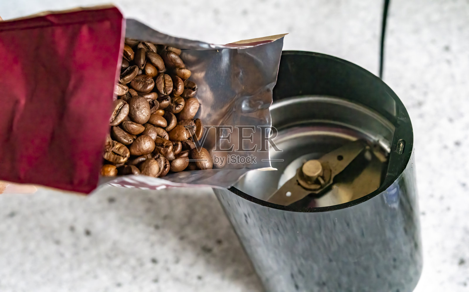 咖啡豆倒进咖啡研磨机照片摄影图片